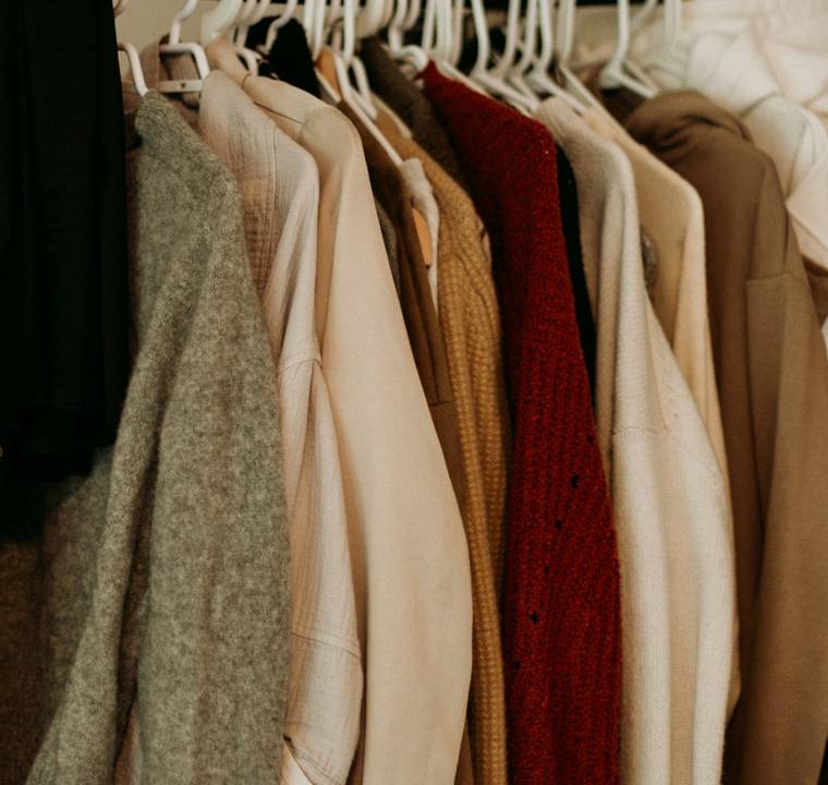 Clothes on a rail in a small boutique